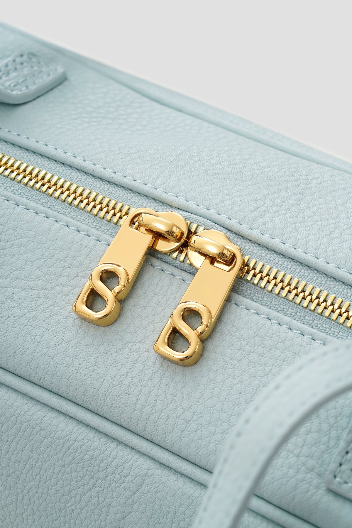 bria shoulder bag in baby blue by buttonscarves secure top zipper detail