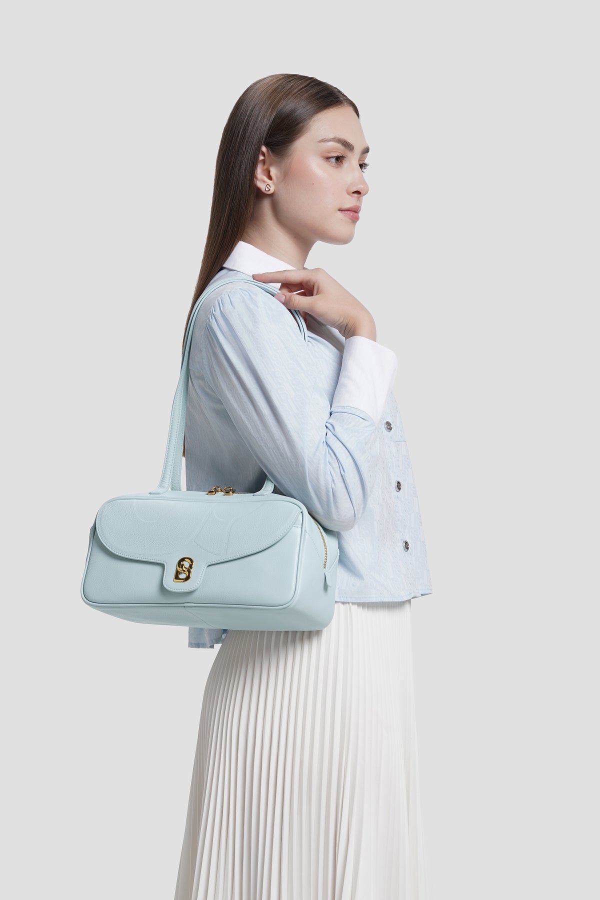 bria shoulder bag in baby blue by buttonscarves carried on shoulder