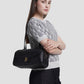 bria shoulder bag in black by buttonscarves carried on shoulder