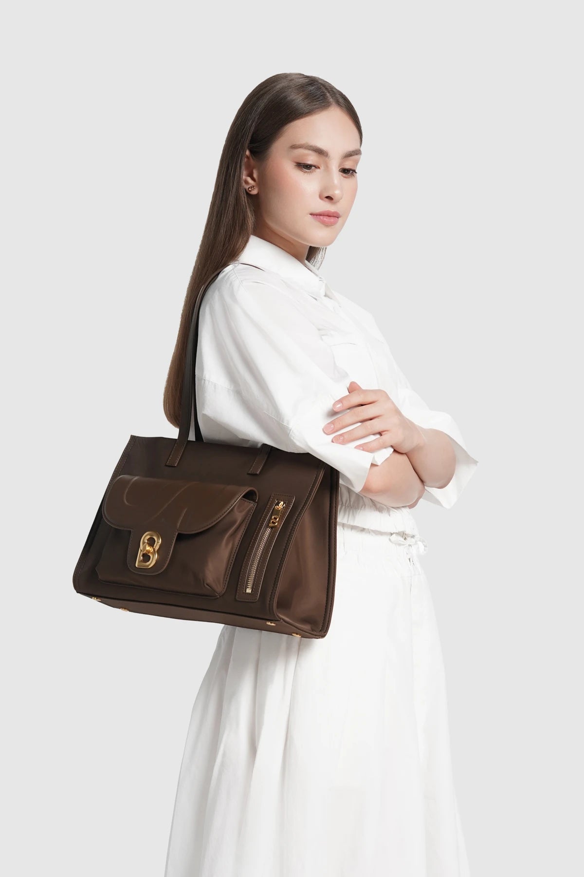 nara tote bag in brown by buttonscarves carried on shoulder