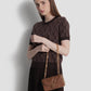 alana small bag in brown by buttonscarves carried on wrist
