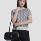 bria shoulder bag in black by buttonscarves carried on wrist