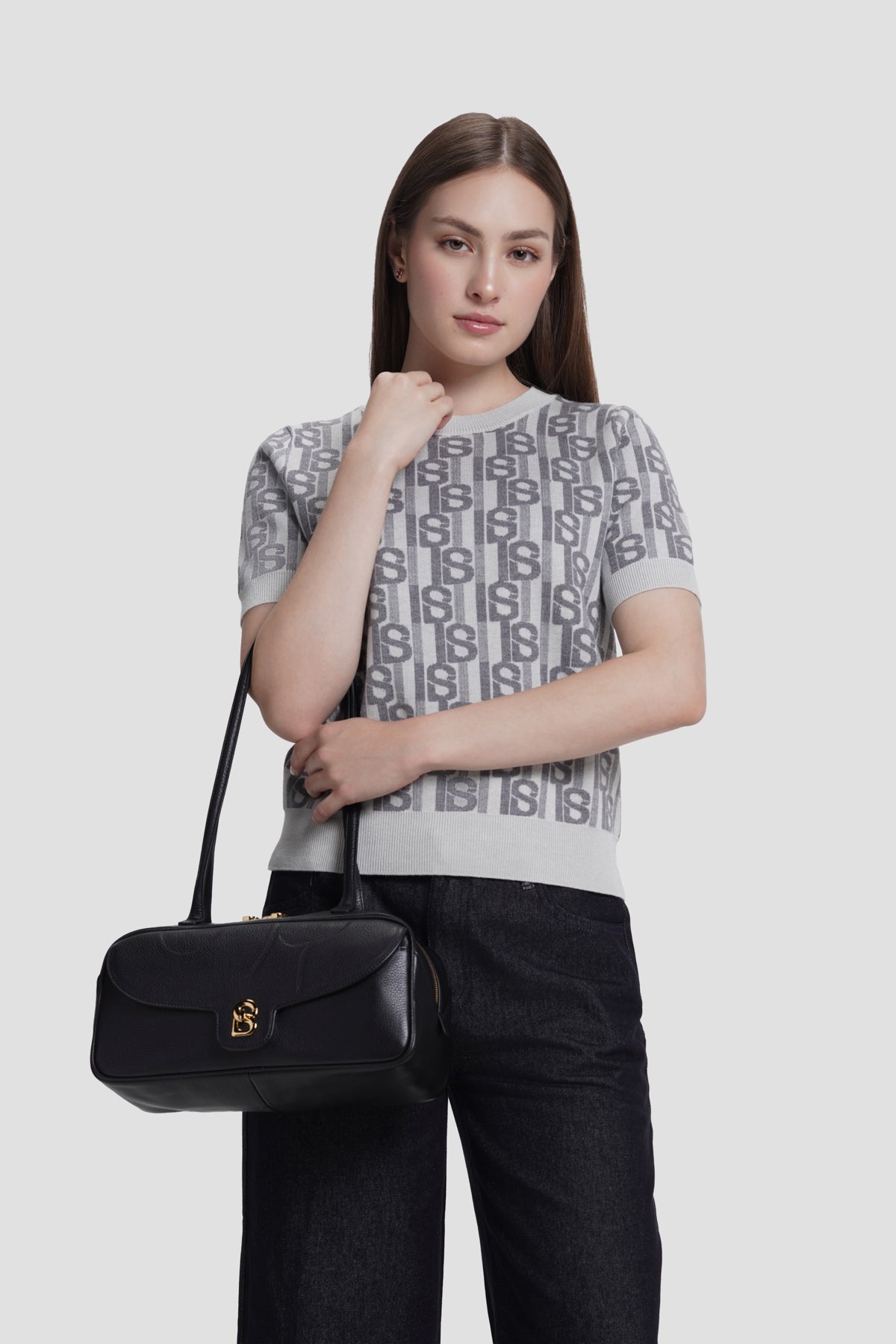 bria shoulder bag in black by buttonscarves carried on wrist