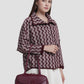 bria shoulder bag in burgundy by buttonscarves carried on wrist