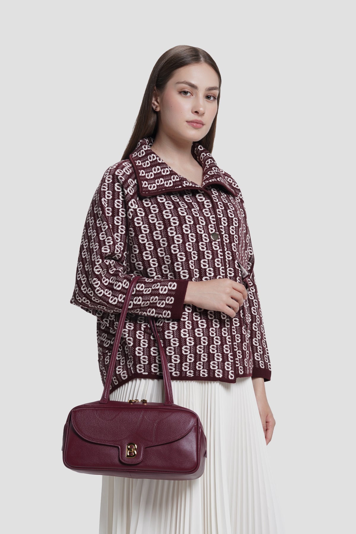 bria shoulder bag in burgundy by buttonscarves carried on wrist