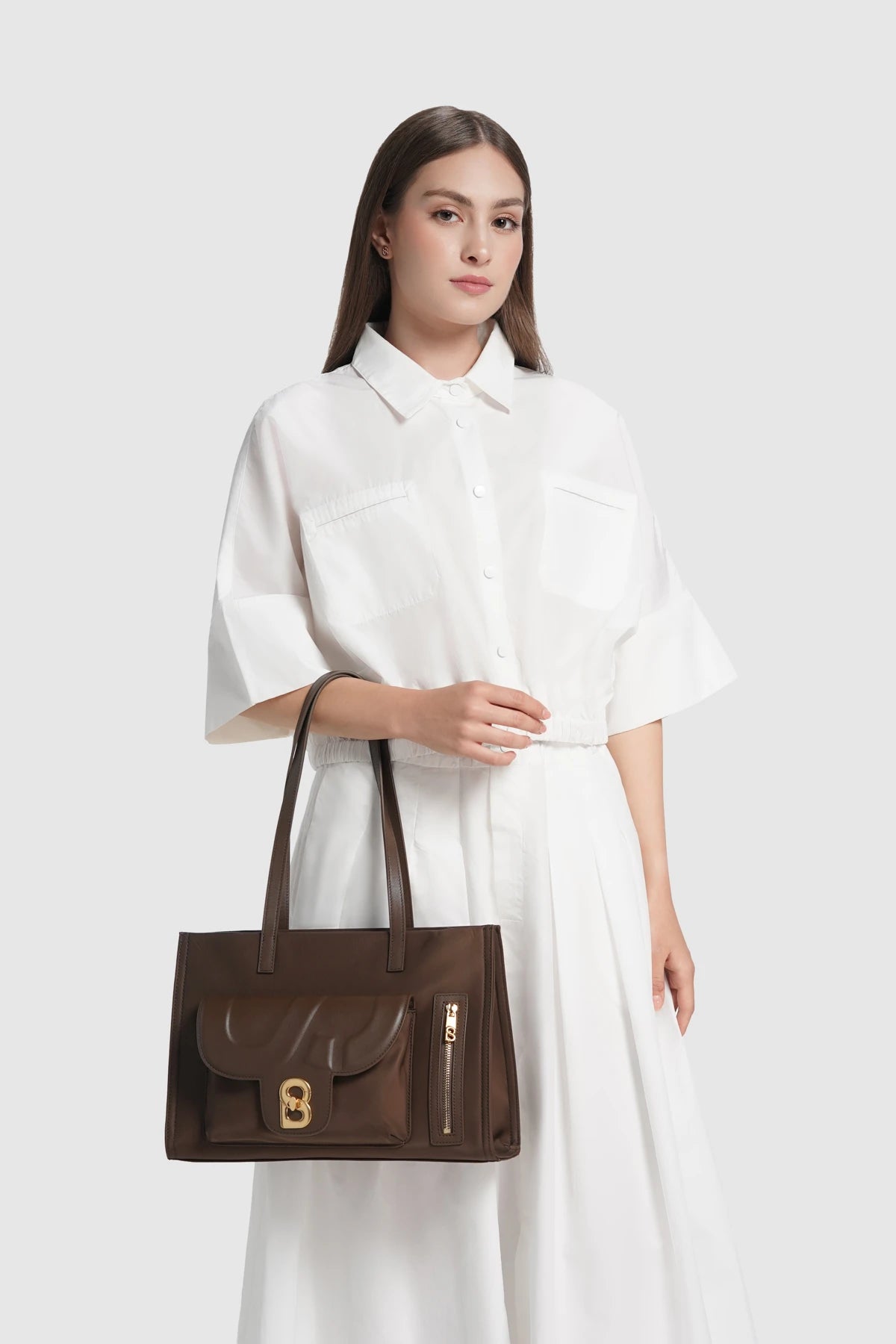 nara tote bag in brown by buttonscarves carried on wrist
