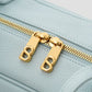 bria shoulder bag in baby blue by buttonscarves secure top zipper detail
