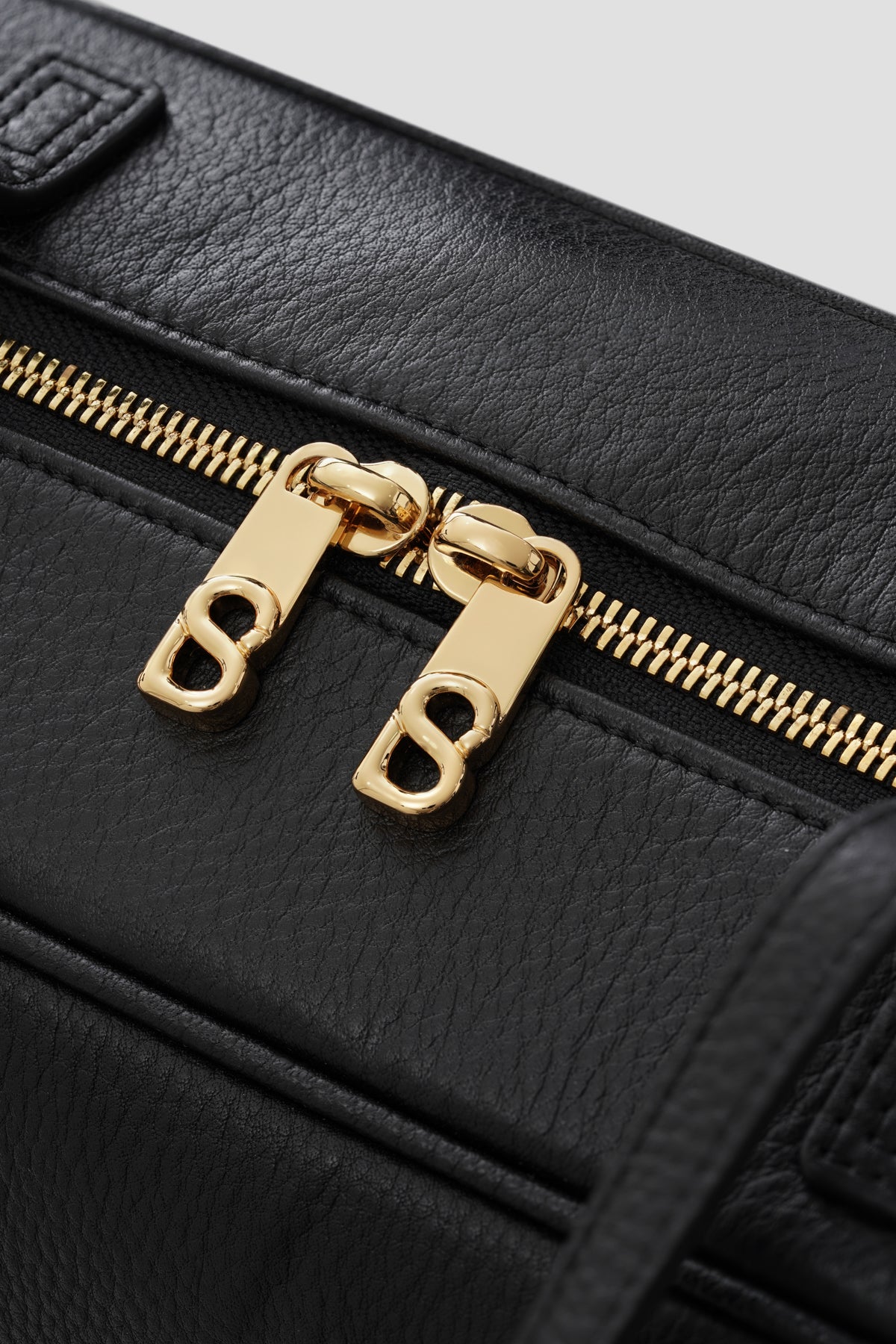 bria shoulder bag in black by buttonscarves secure top zipper detail