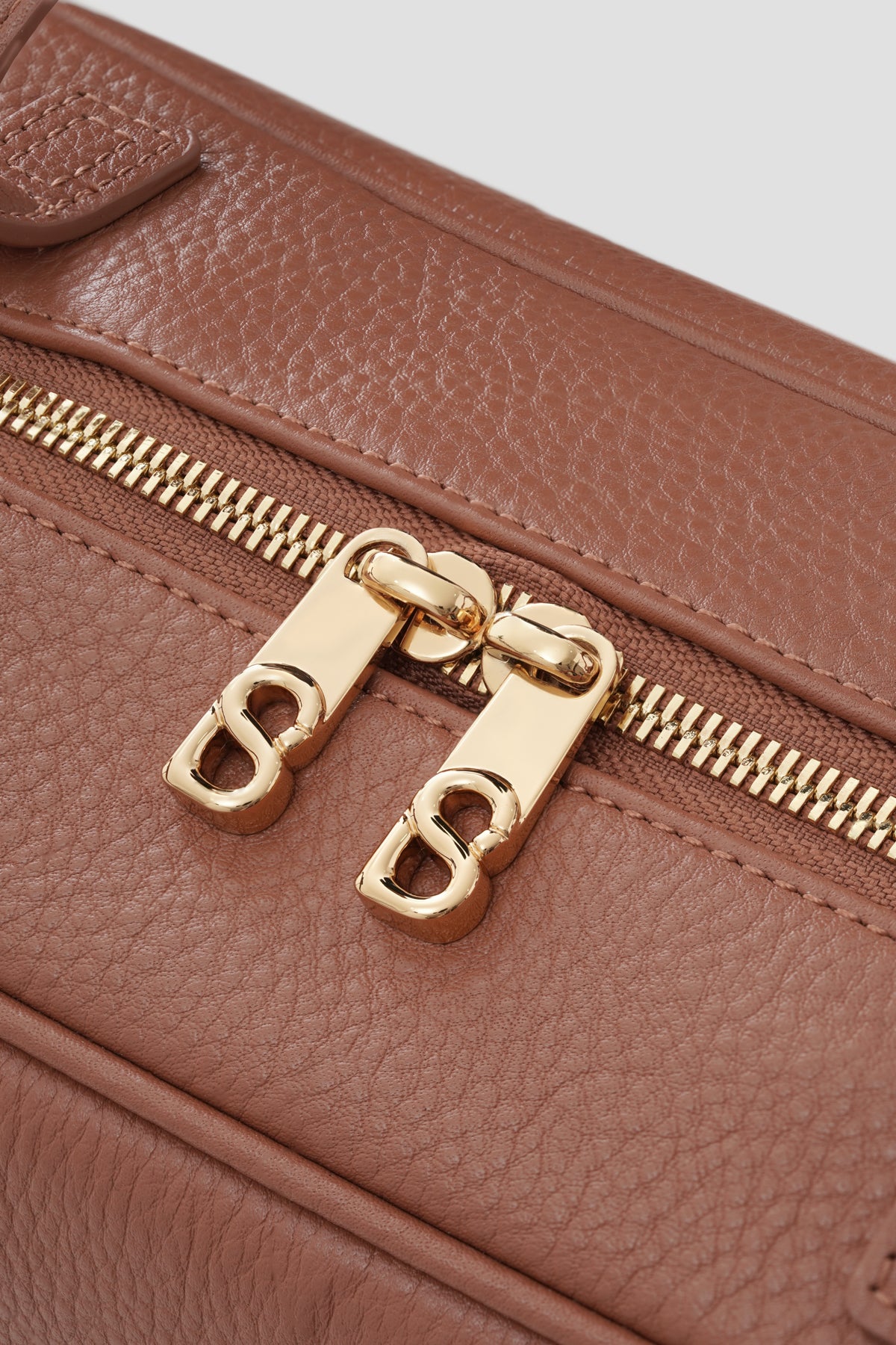 bria shoulder bag in caramel by buttonscarves secure top zipper detail