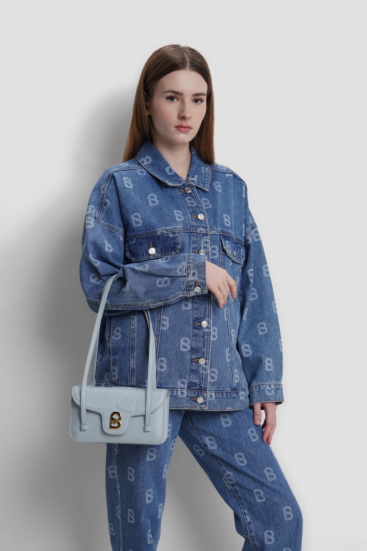 alka shoulder bag in azure by buttonscarves carried on wrist