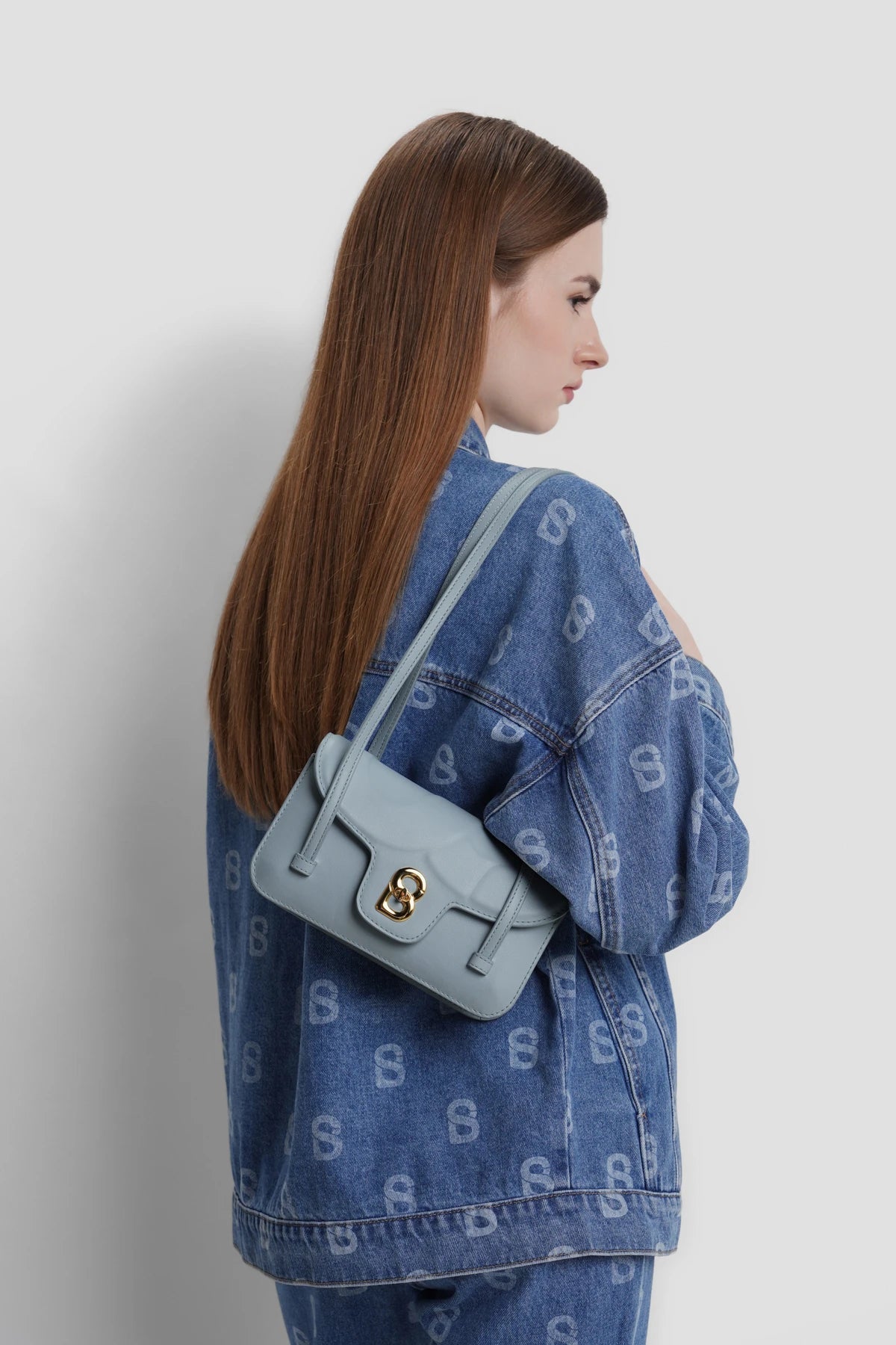 alka shoulder bag in azure by buttonscarves carried on shoulder
