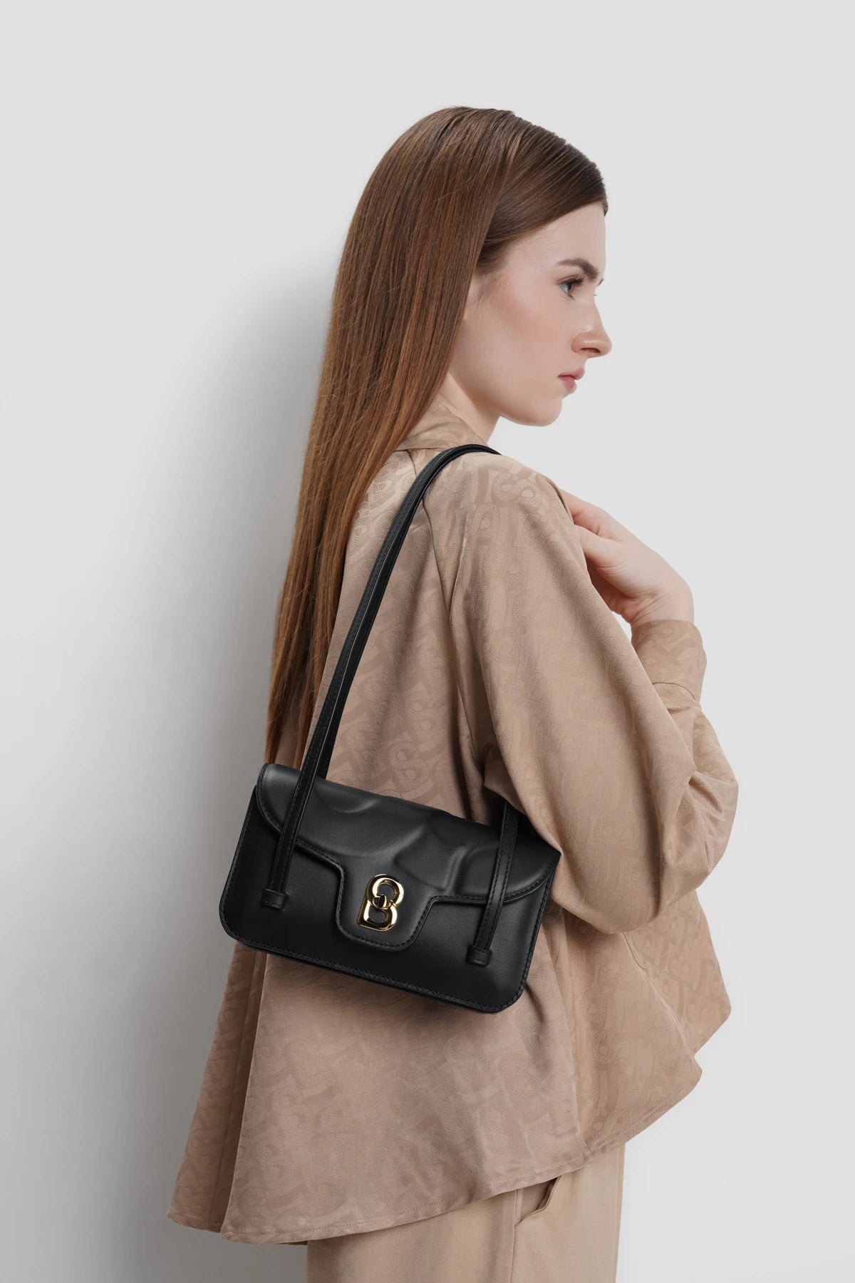 alka shoulder bag in black by buttonscarves carried on shoulder