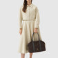 aveline bag in dark brown by buttonscarves carried by hand