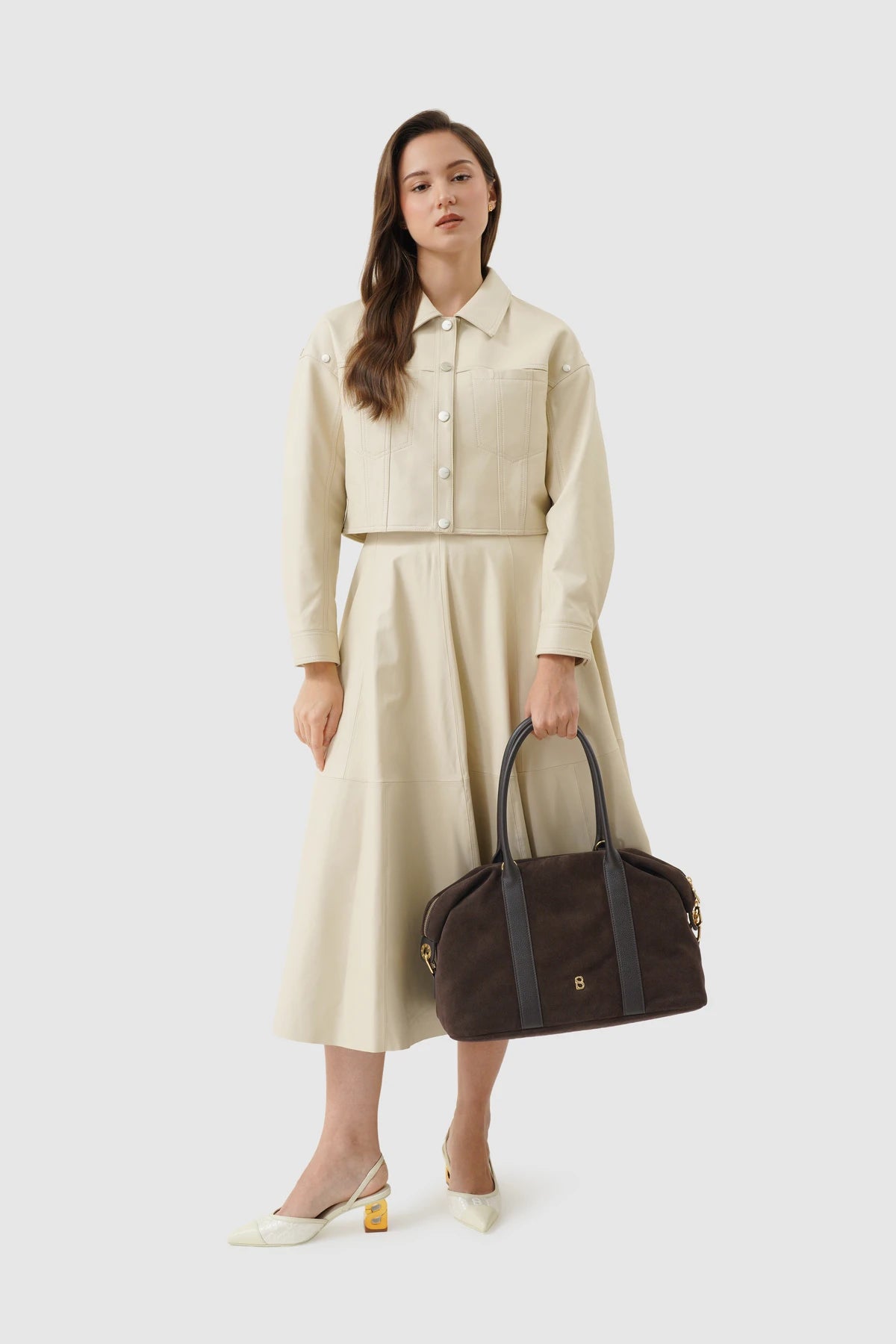 aveline bag in dark brown by buttonscarves carried by hand