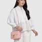 Model memakai tas Buttonscarves Alba Bag Medium warna dusty pink