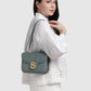 Model memakai Buttonscarves Alba Bag Medium warna hijau tampak samping