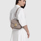 Model memakai Buttonscarves Alba Bag Medium warna Taupe tampak samping